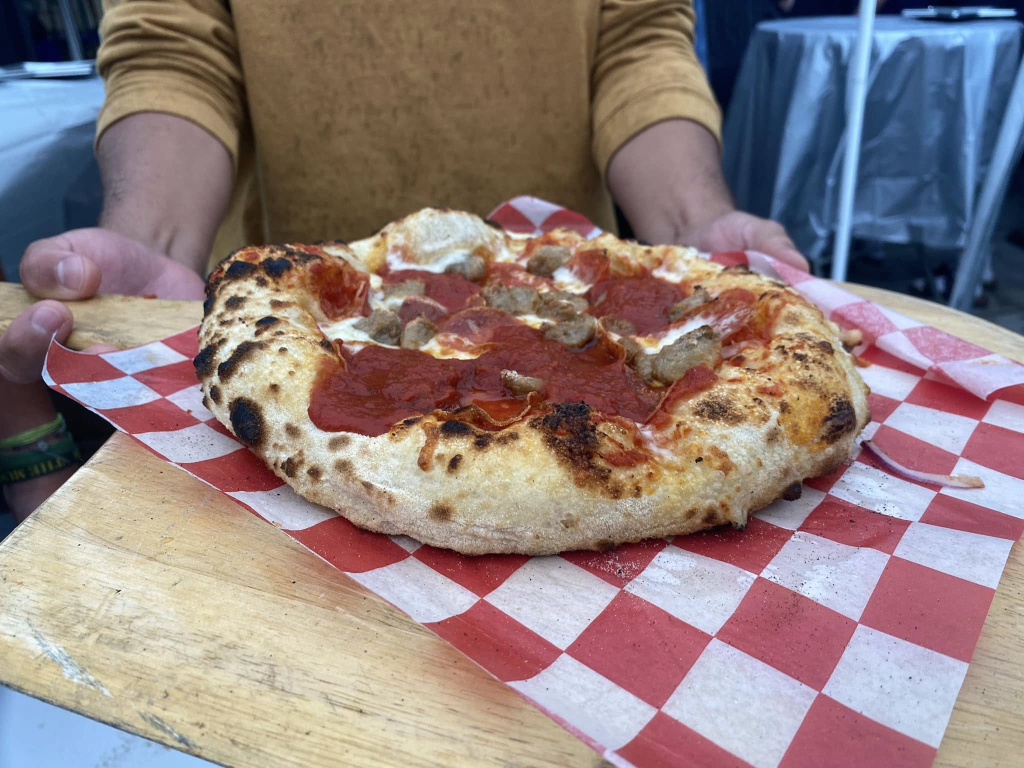 Fresh wood-fired pizza with bubbling cheese